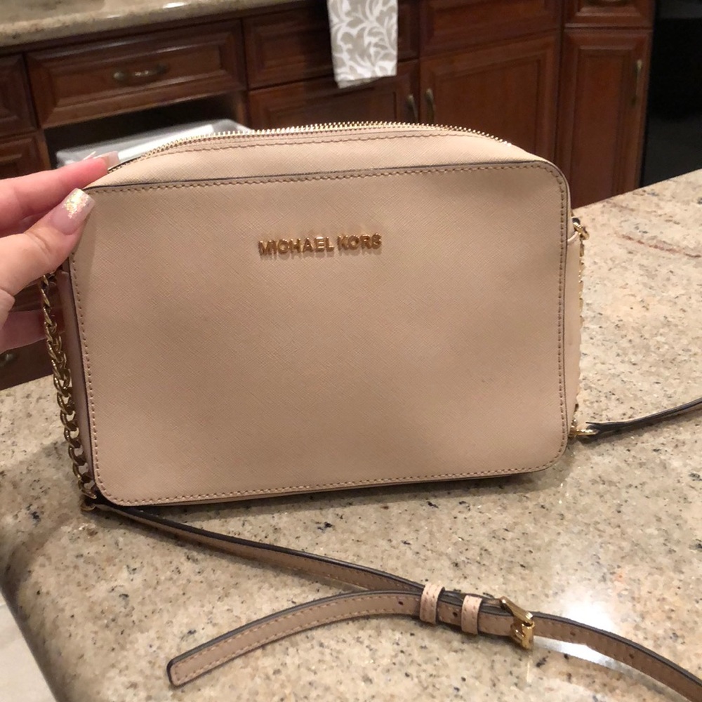 a small, light pink cross body.
